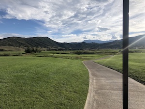 a golf course outside of a mountain town